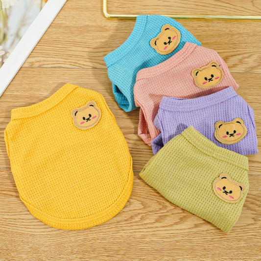Assorted solid color pet vests in yellow, blue, pink, purple, and green with a small bear patch