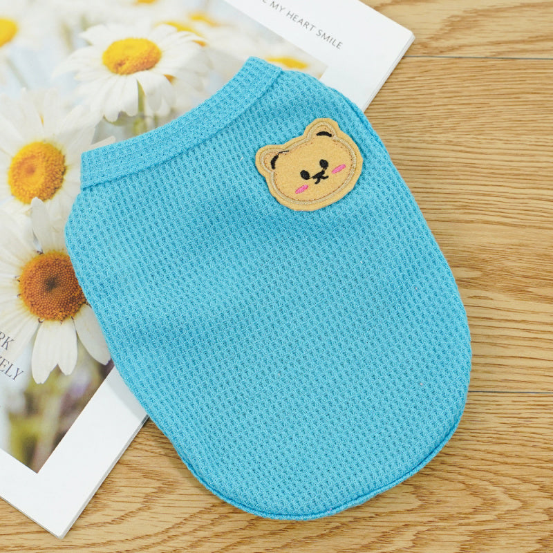 Light blue pet vest with a small bear patch detail, sleeveless design for small pets
