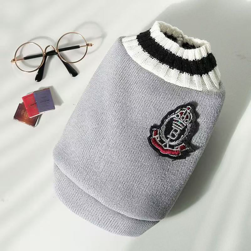 Grey knitted pet sweater vest with a formal crest emblem patch for autumn and winter wear
